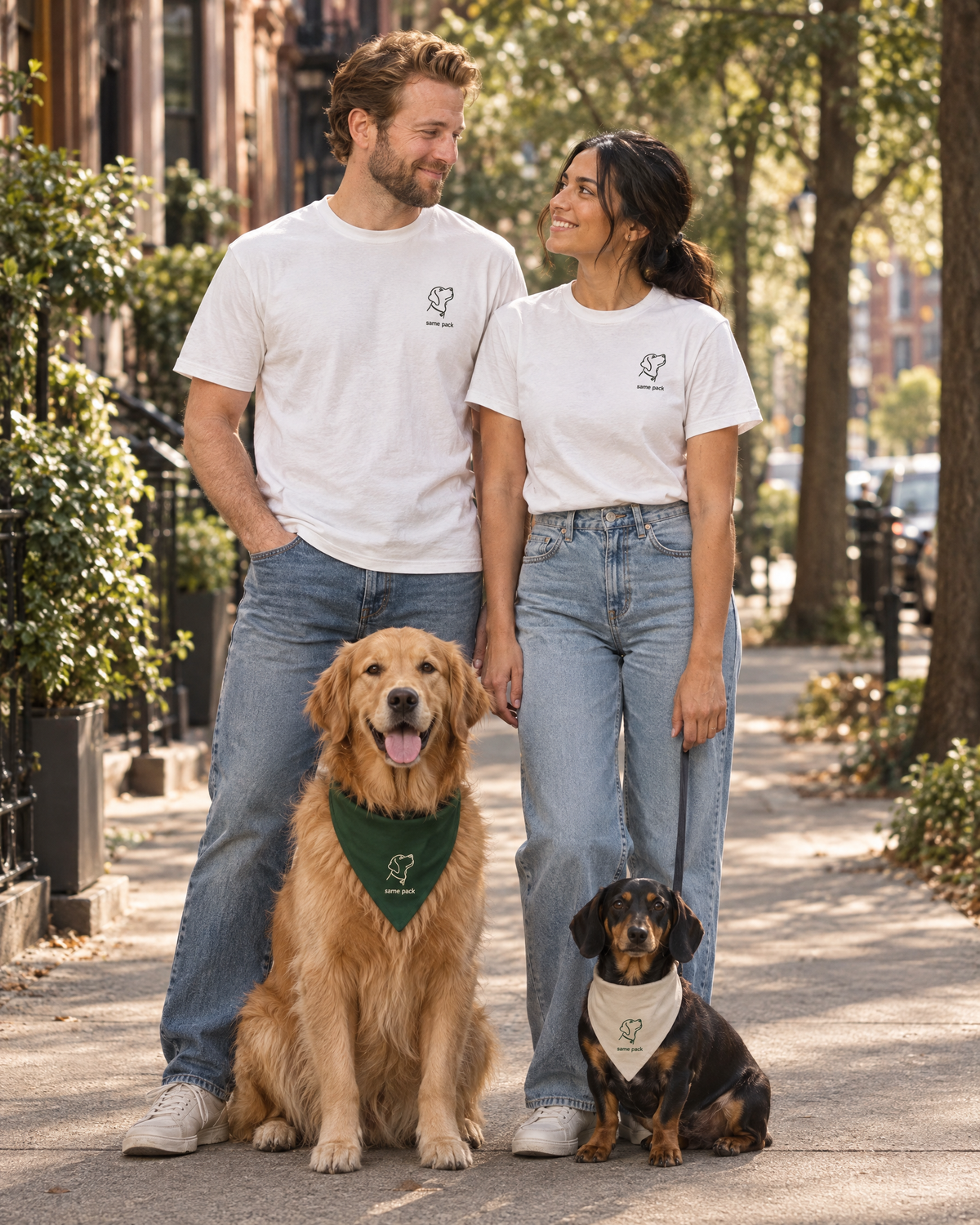 Couple wearing matching The Minimal Tee White with their dogs