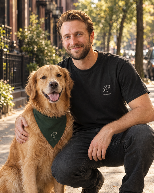 Man wearing The Minimal Tee Black with his golden retriever